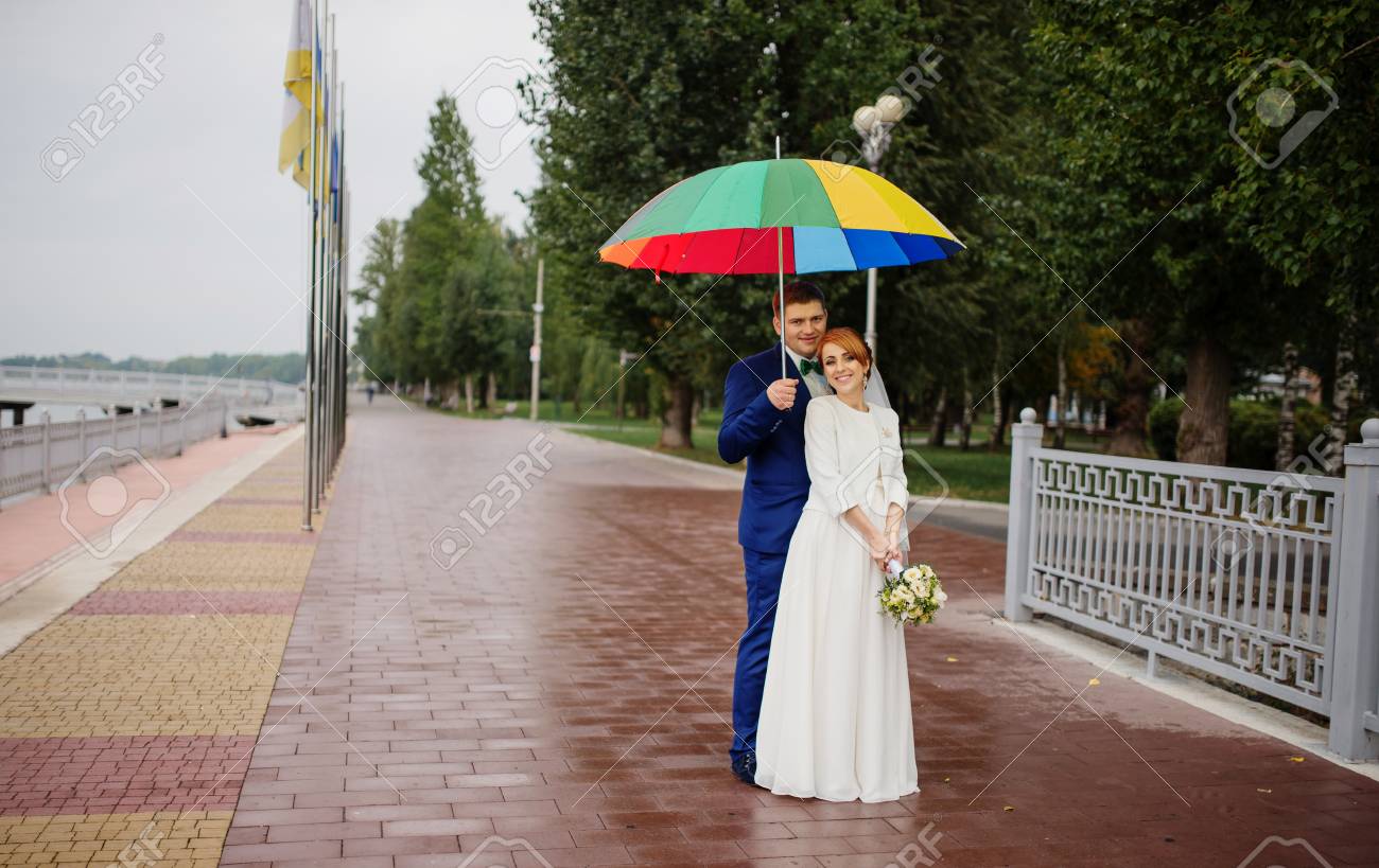 Wedding Couple In Love Under Coloured Umbrella At Rain Stock Photo Picture And Royalty Free Image Image
