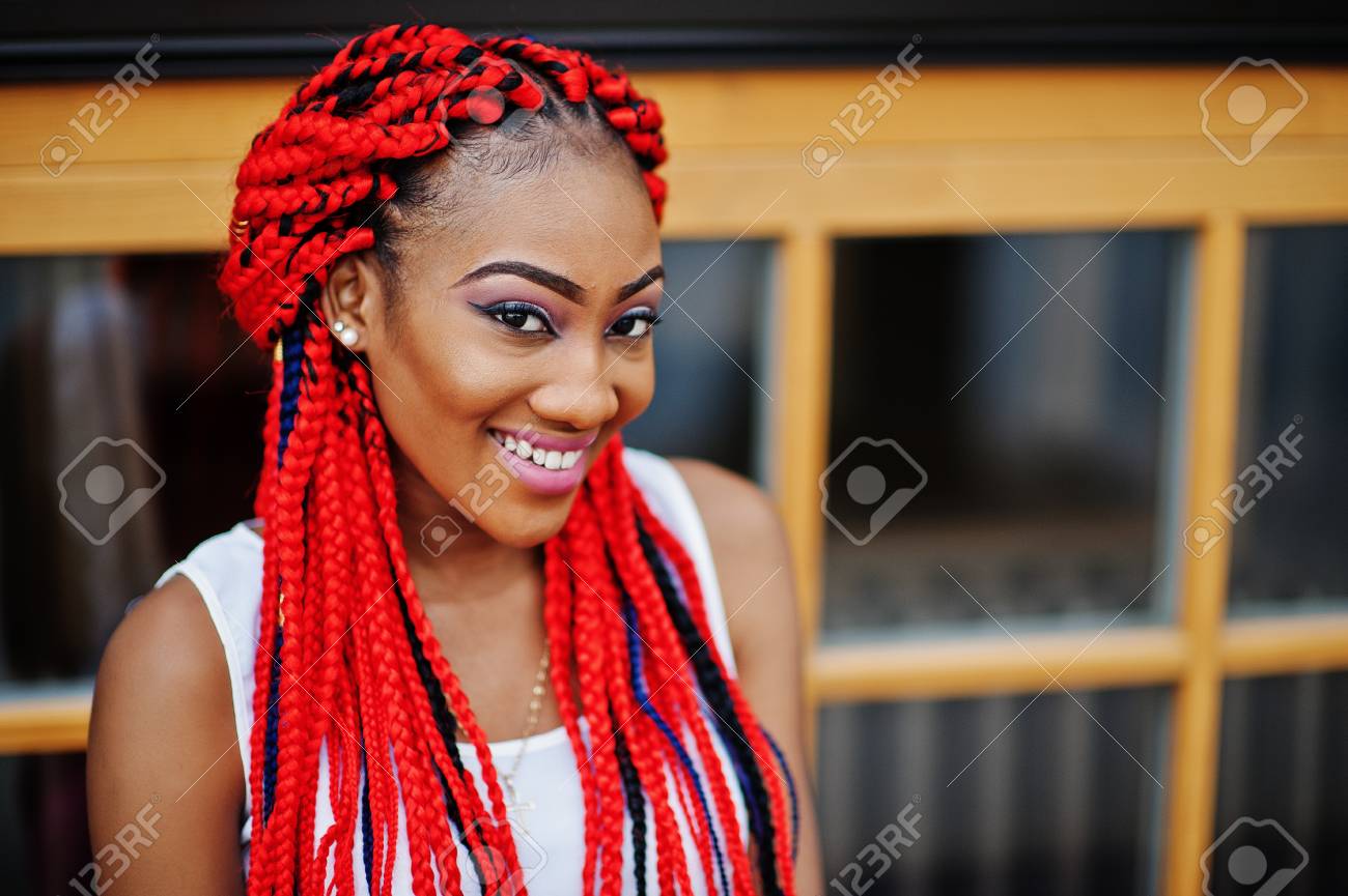 Fashionable African American Girl At Pink Pants And Red Dreads