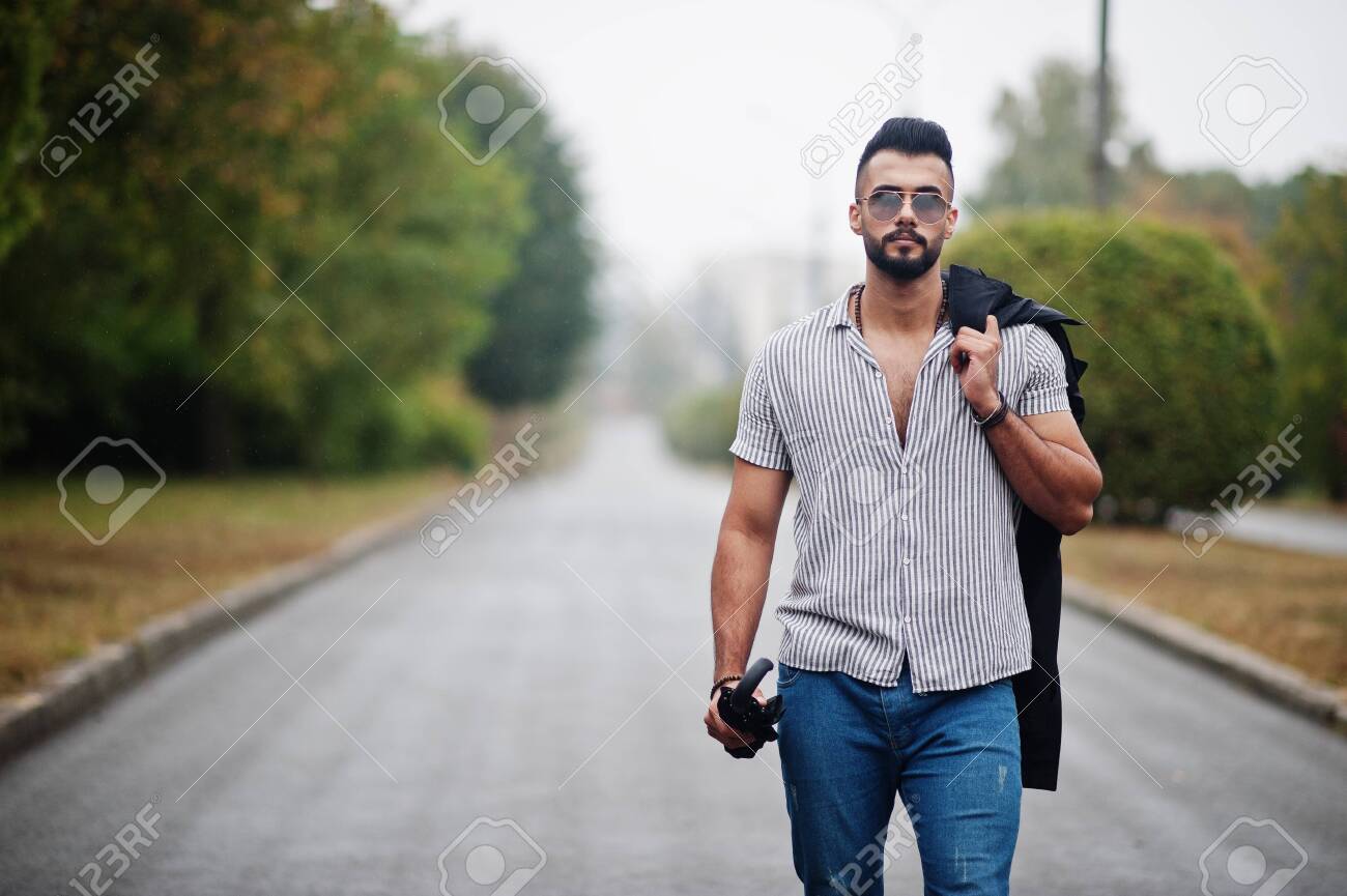Fashionable Tall Arab Beard Man Wear On Shirt Jeans And Sunglasses Walking At Park With Umbrella And Coat At Hand Stock Photo Picture And Royalty Free Image Image 131317463
