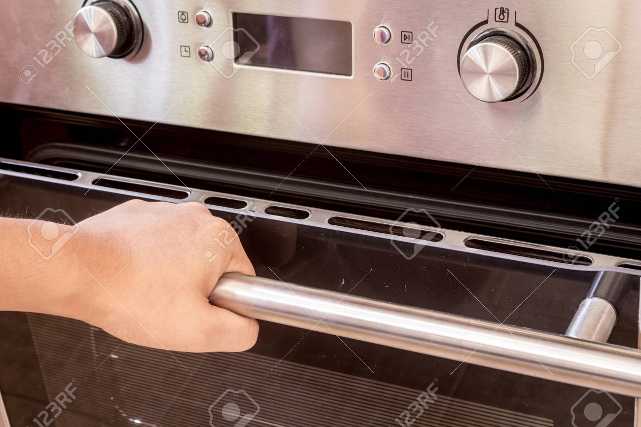 Hand Opening The Oven Door Stock Photo Picture And Royalty Free Image Image 88593218
