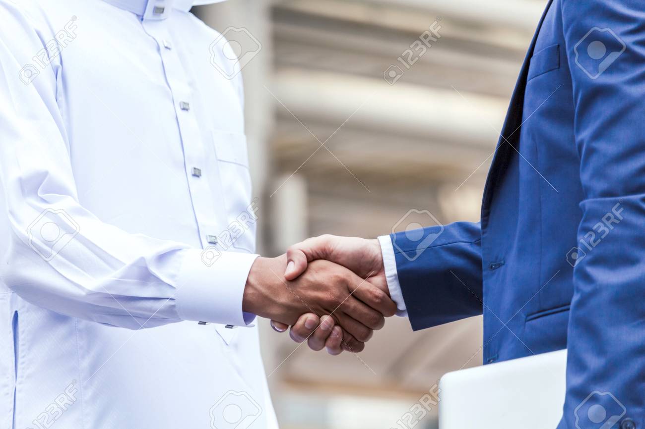 Successful businessmen handshake partner with arab businessman - 98984520 Successful businessmen handshake partner with arab businessman - 98984520