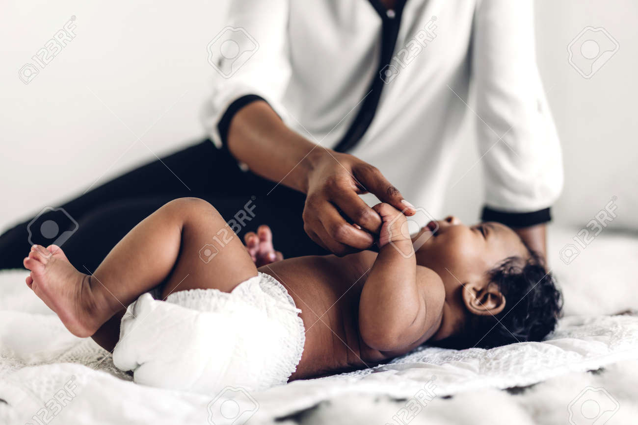 African american mother playing with adorable little african american baby in a white bedroom.Love of black family concept - 168606998 African american mother playing with adorable little african american baby in a white bedroom.Love of black family concept - 168606998