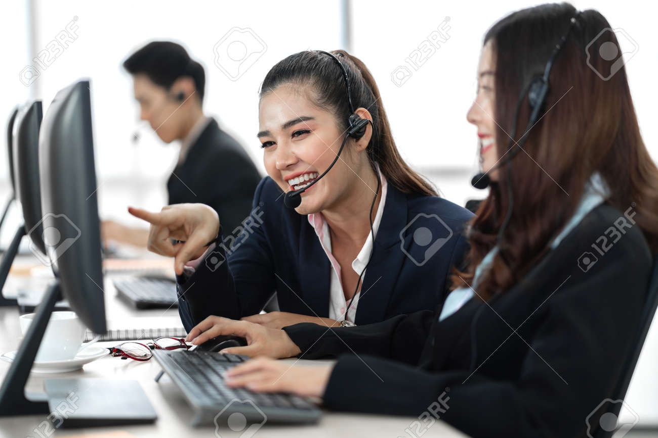 Group of happy call center smiling business operator customer support team phone services working with headset and computer at call center - 168607005 Group of happy call center smiling business operator customer support team phone services working with headset and computer at call center - 168607005