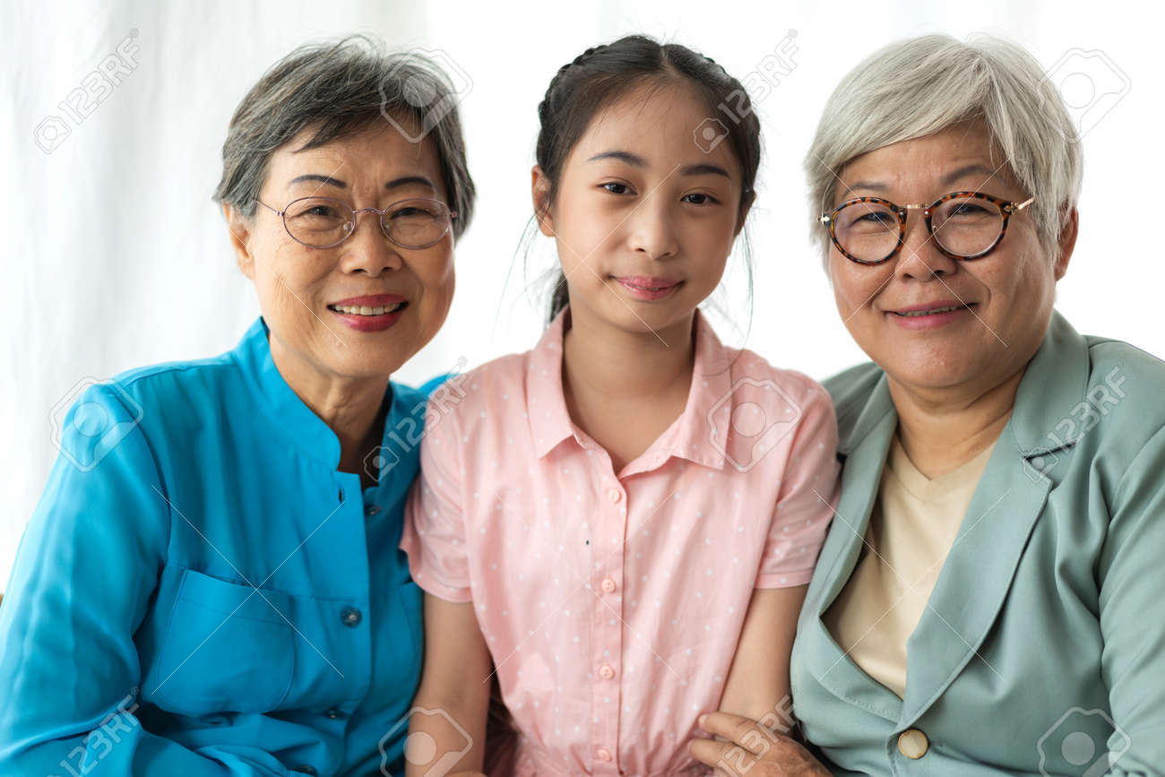 Portrait of happy asian grandmother and little cute girl enjoy relax together look at camera.Family and togetherness - 168607006 Portrait of happy asian grandmother and little cute girl enjoy relax together look at camera.Family and togetherness - 168607006