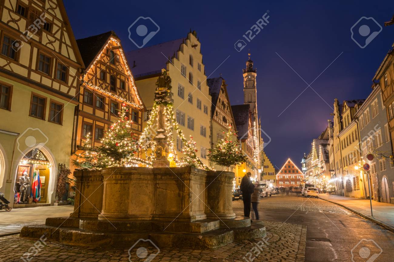 a festively decorated fountain near the christmas market in rothenburg christmas markets