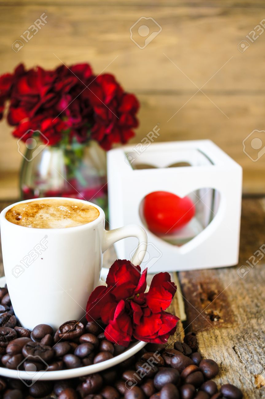 Cup Of Coffee And Red Cloves Flowers In A Vase With Good Morning