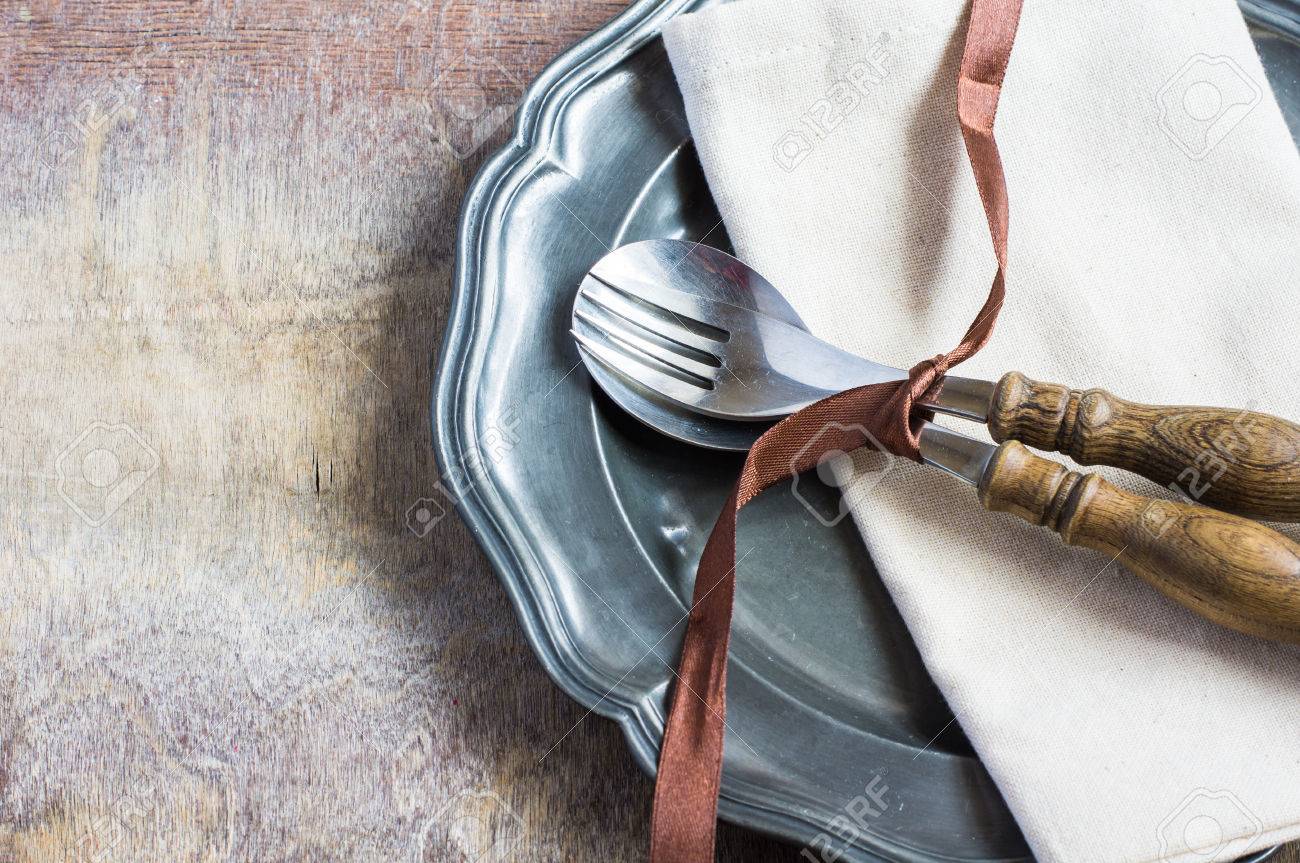 Rustic Table Setting With Bright Napkin, Silverware And Plate ... Rustic Table Setting With Bright Napkin, Silverware And Plate ...