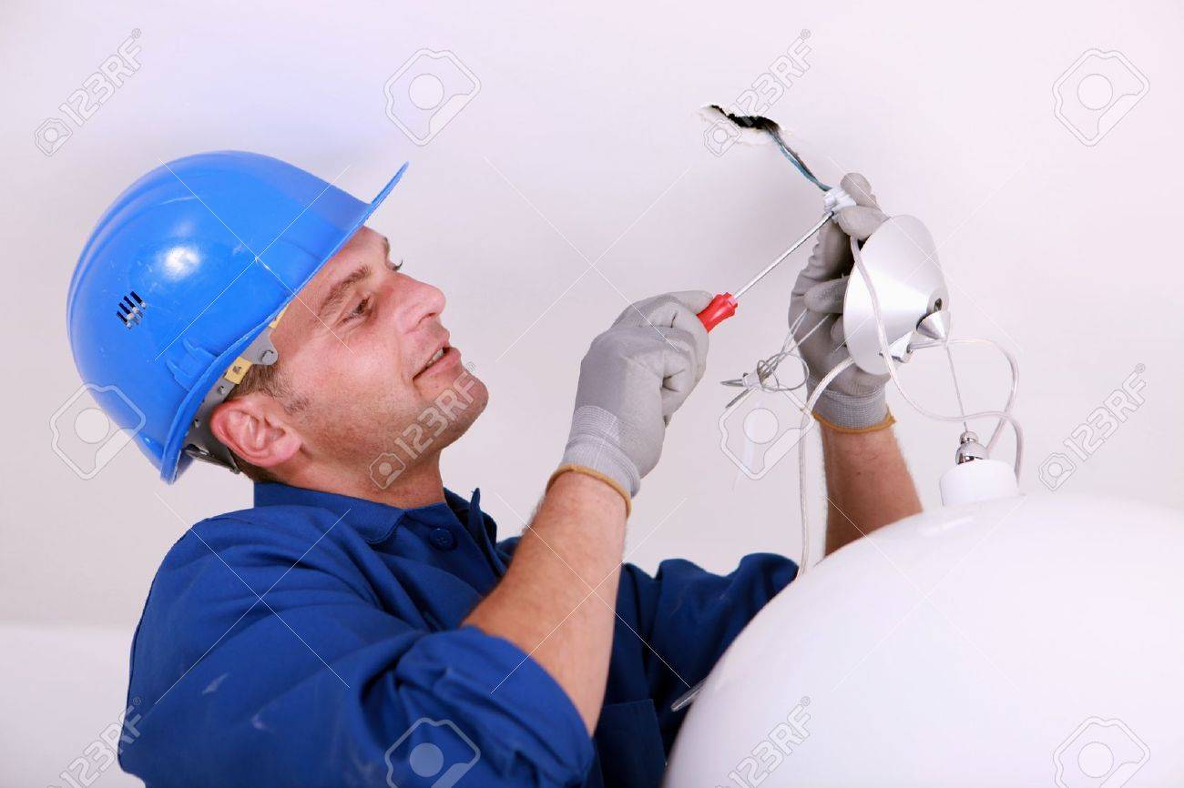 Electrician Wiring A Ceiling Light Stock Photo