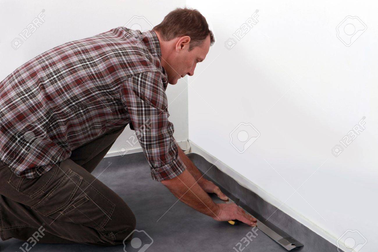 Tradesman Laying Down Linoleum Flooring Stock Photo Picture And