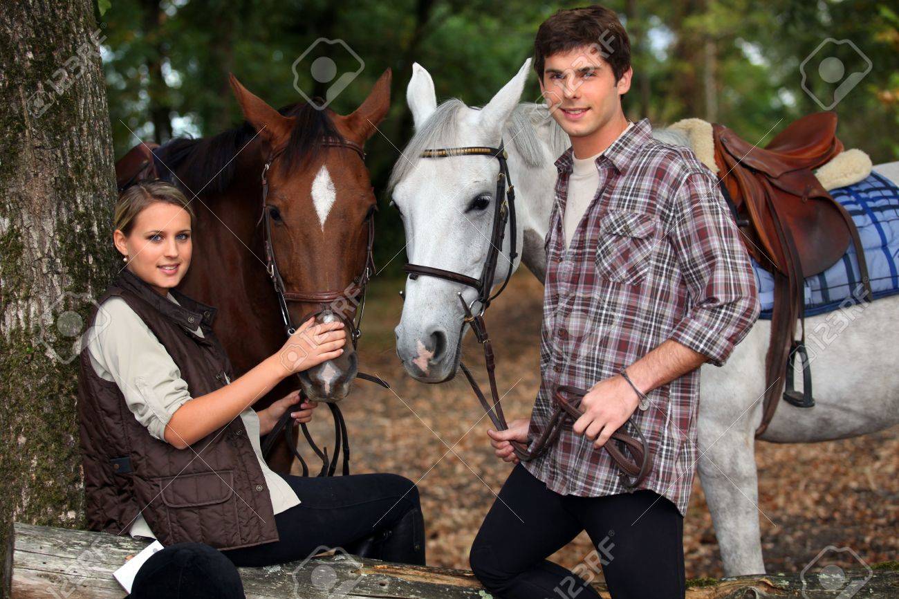 Young Boy And Girl Riding Horses Stock