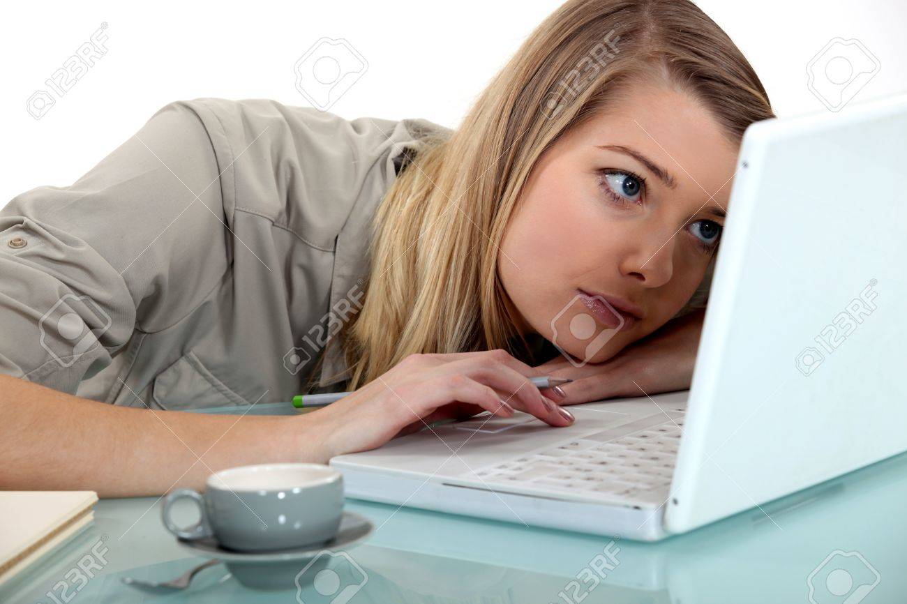 young woman bored in front of computer stock photo picture and