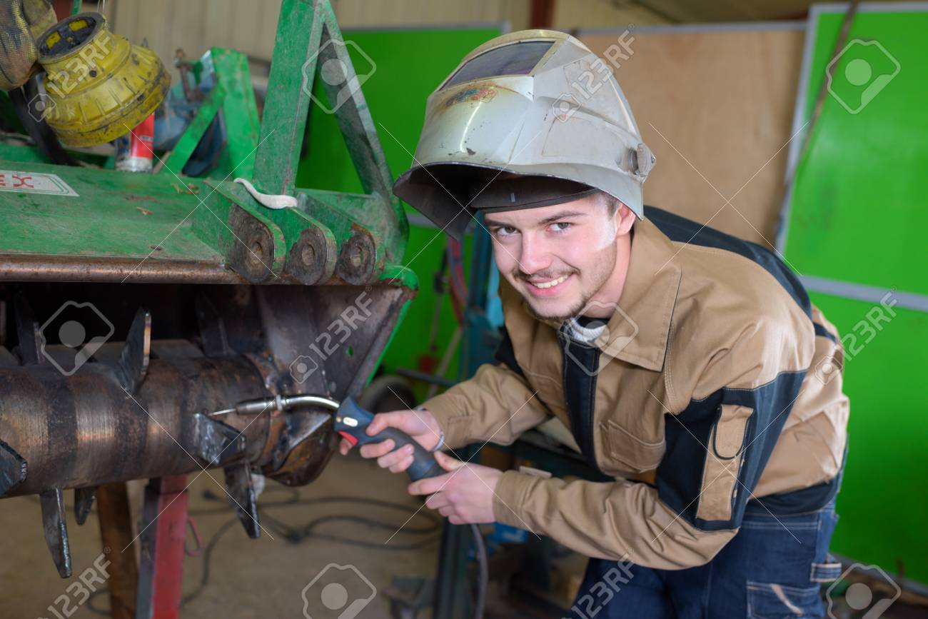 happy apprentice welder at work in the plant stock photo picture apprentice welder
