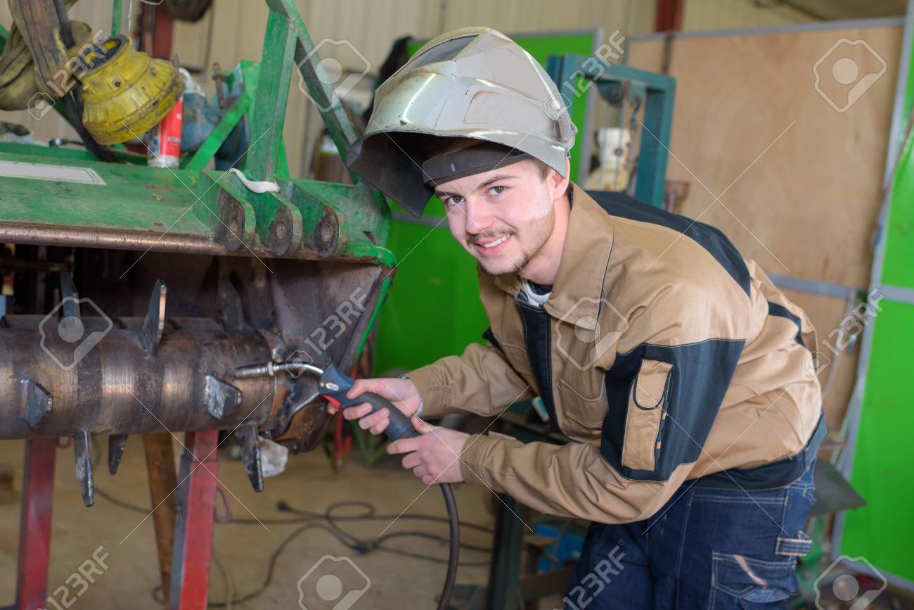 happy apprentice welder at work in the plant stock photo picture apprentice welder
