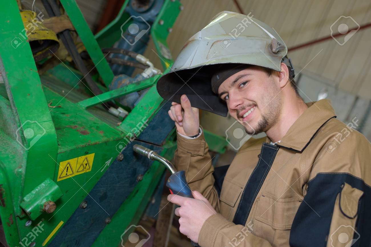 happy apprentice welder at work in the plant stock photo picture apprentice welder