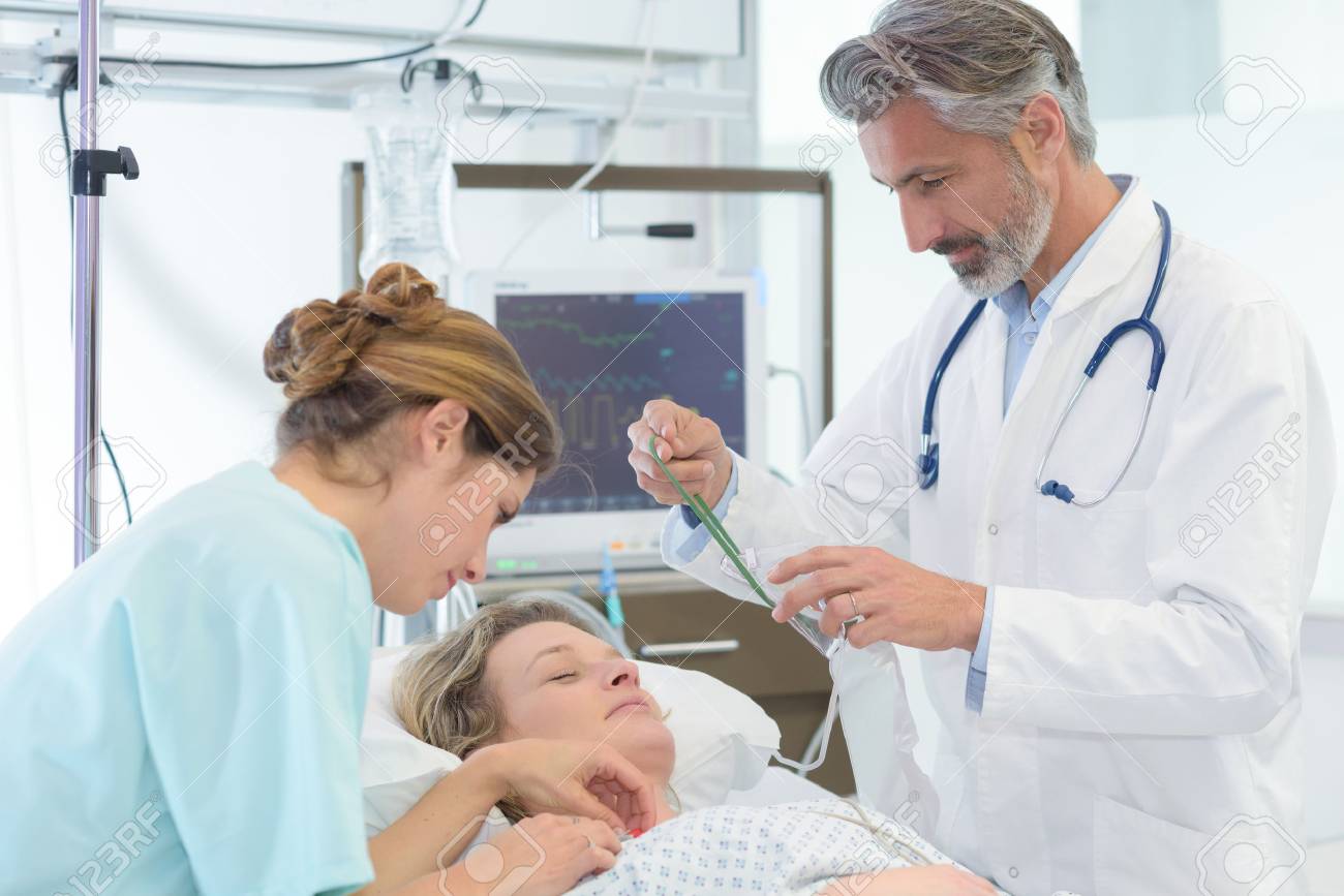 doctor nurse and female patient in bed - 88263970 doctor nurse and female patient in bed - 88263970