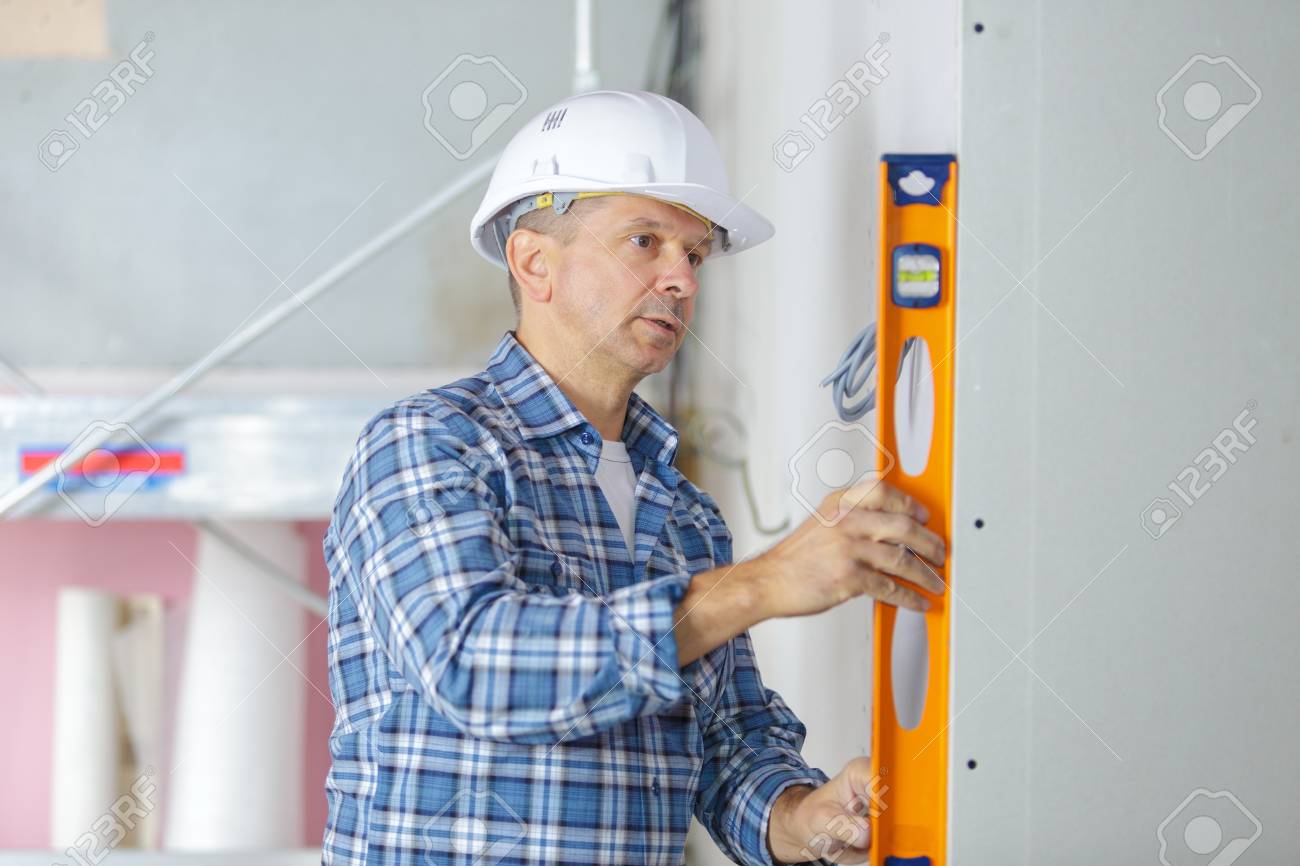 Professional Builder With Spirit Level At Construction Site Stock Photo Picture And Royalty Free Image Image