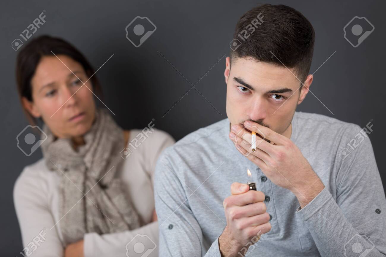 Young Man Smoking Cigarette And Get