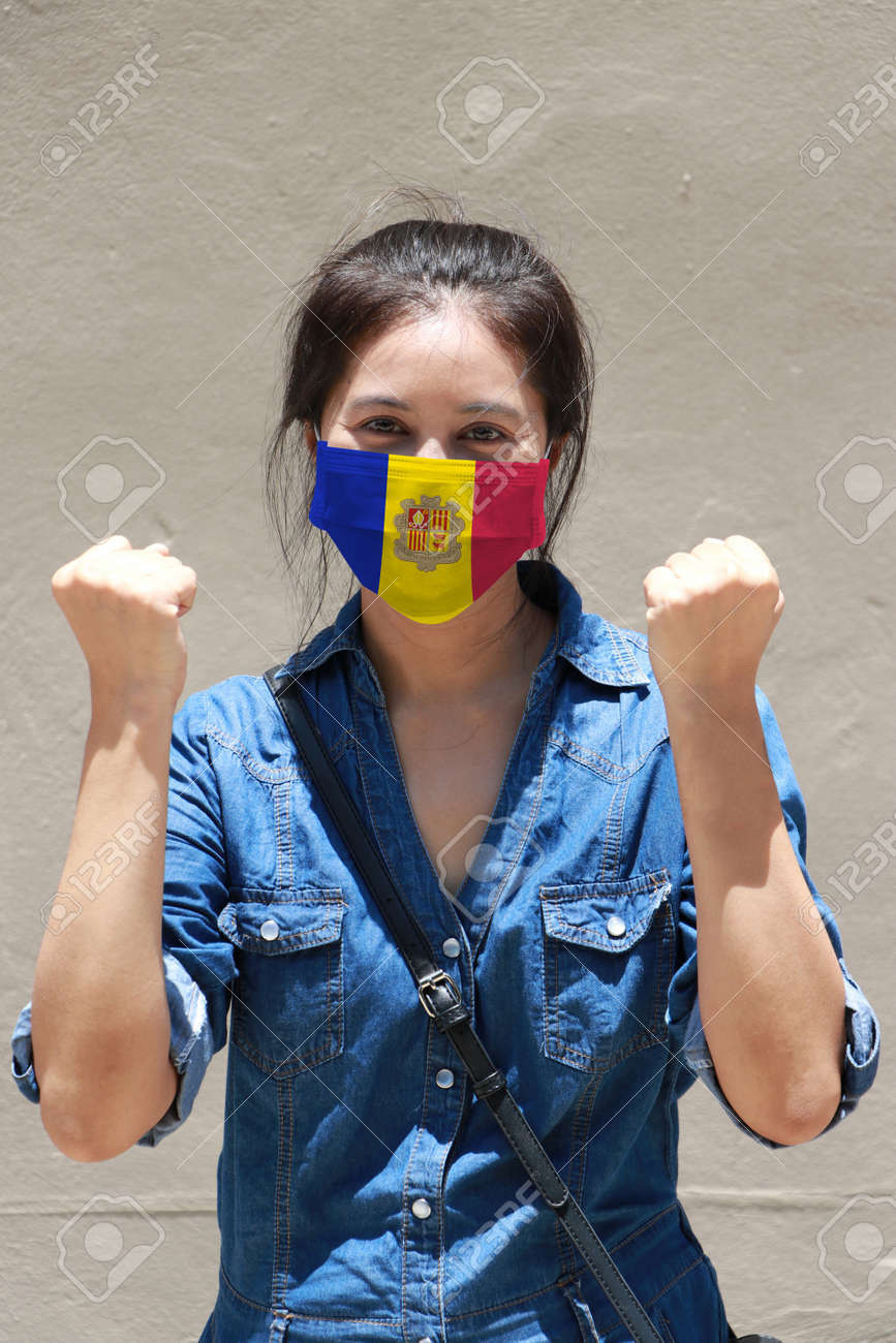 Andorra flag on hygienic mask. Masked woman prevent germs and wear denim dress. Tiny Particle or respiratory disease protection. Concept of Combating illness. - 158803108 Andorra flag on hygienic mask. Masked woman prevent germs and wear denim dress. Tiny Particle or respiratory disease protection. Concept of Combating illness. - 158803108