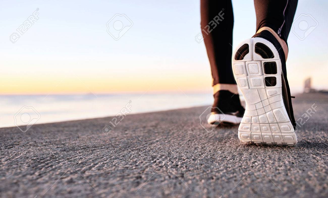 Athlete runner feet running on treadmill closeup on shoe. Jogger fitness shoe in the background and open space around him. Runner jogging training workout exercising power walking outdoors in city. - 52008741 Athlete runner feet running on treadmill closeup on shoe. Jogger fitness shoe in the background and open space around him. Runner jogging training workout exercising power walking outdoors in city. - 52008741