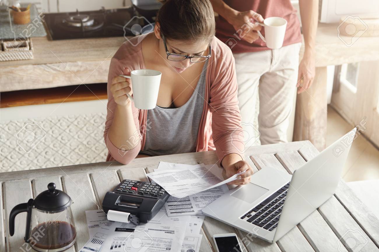 top view of serious young woman wearing glasses managing family