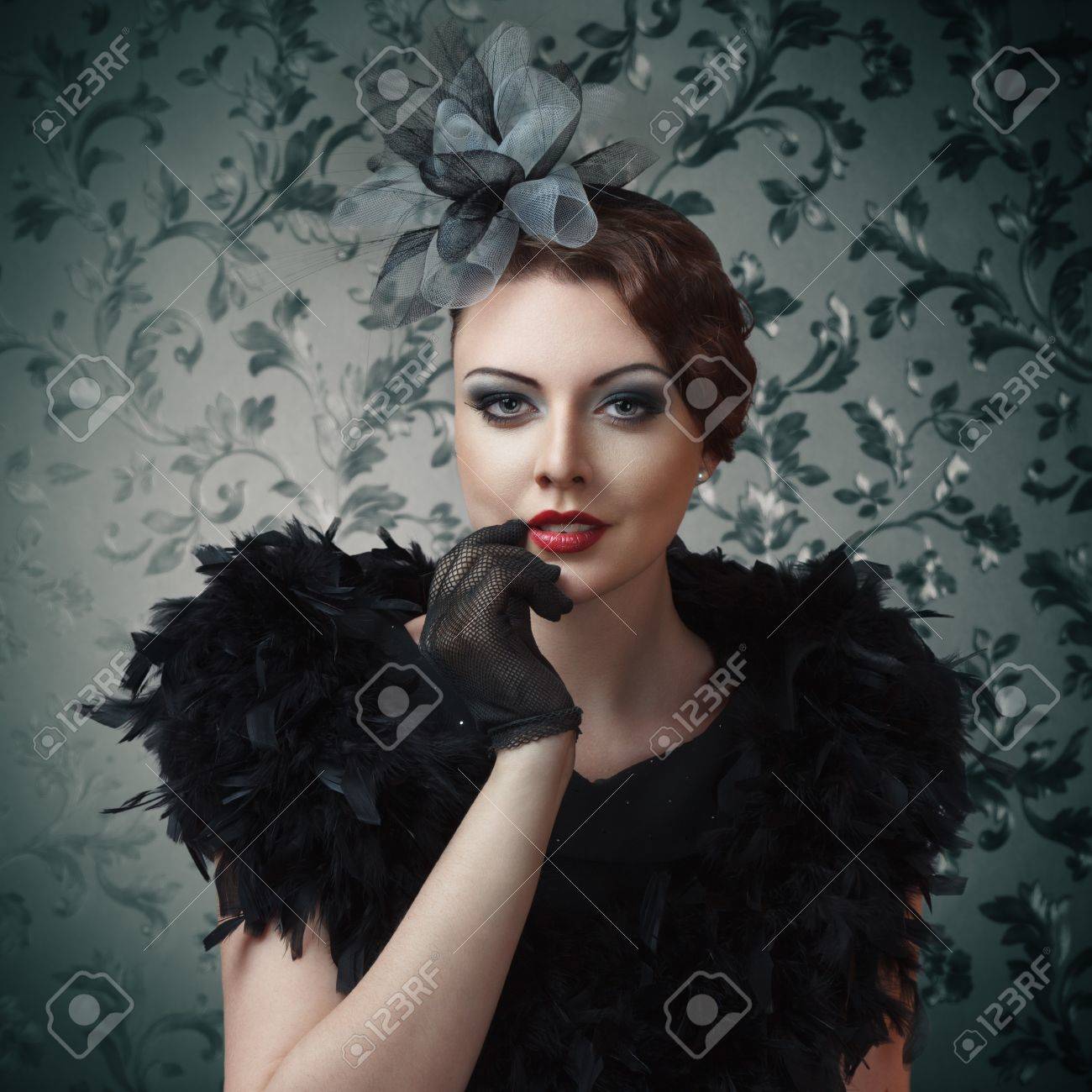 Retro style portrait of young sexy girl touching lips against..