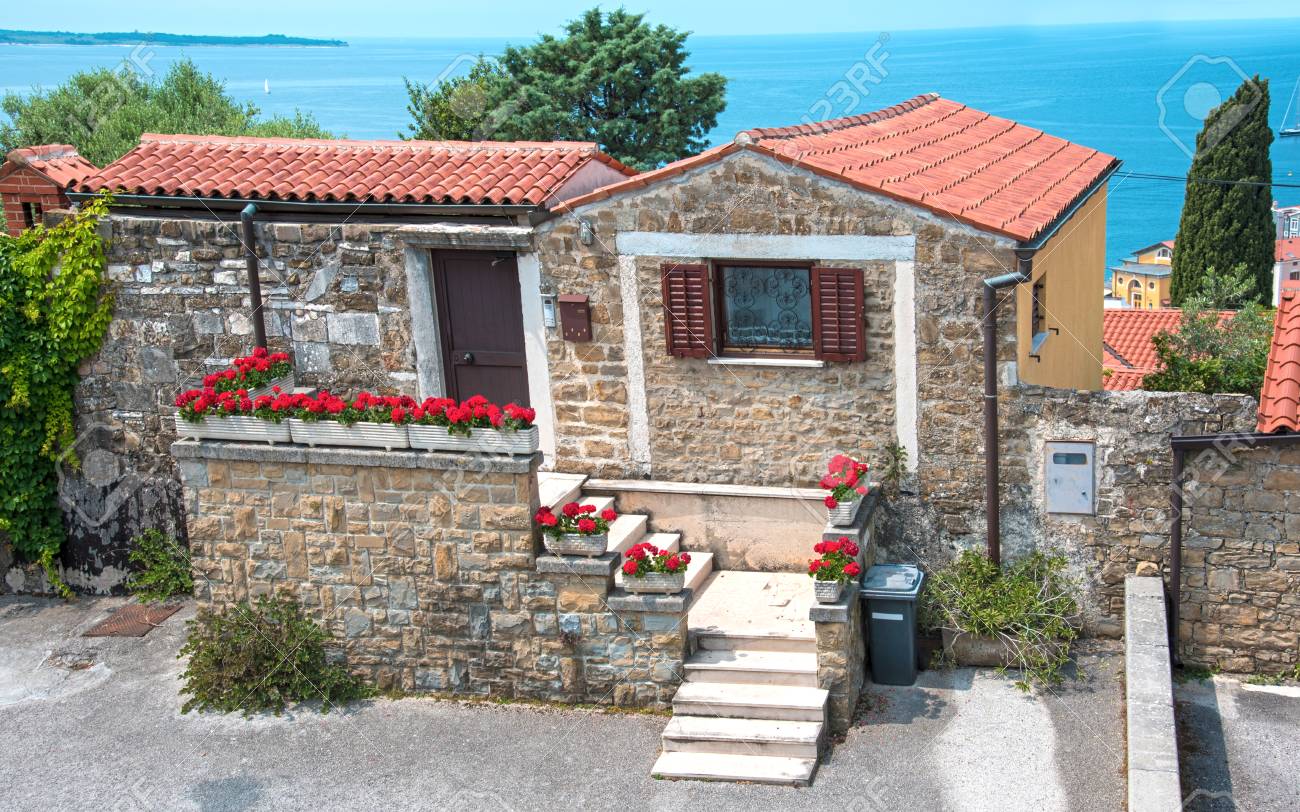 Beautiful landscape with a cozy little house with flowers in porec croatia tourist center stock