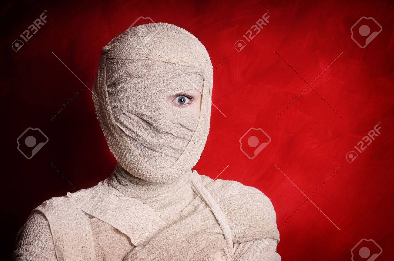 woman wrapped up with bandages as a mummy halloween costume - 32613809 woman wrapped up with bandages as a mummy halloween costume - 32613809