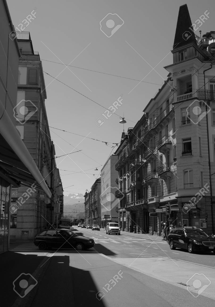 Black And White Of Street In Lucerne Switzerland With Alps In