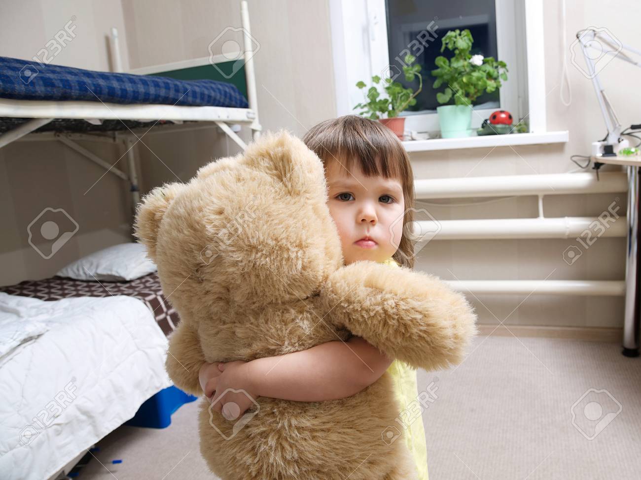kid hugging teddy bear