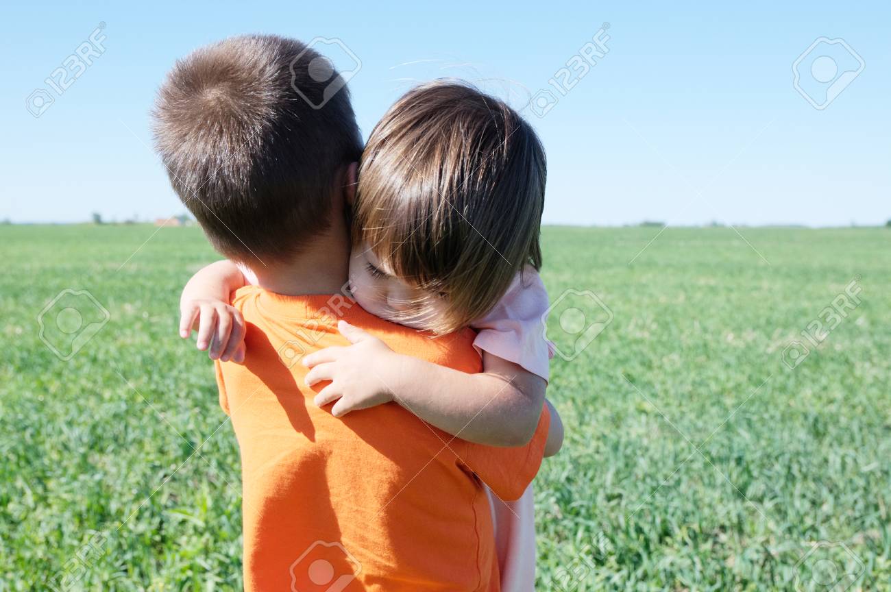 little girl hugging boy
