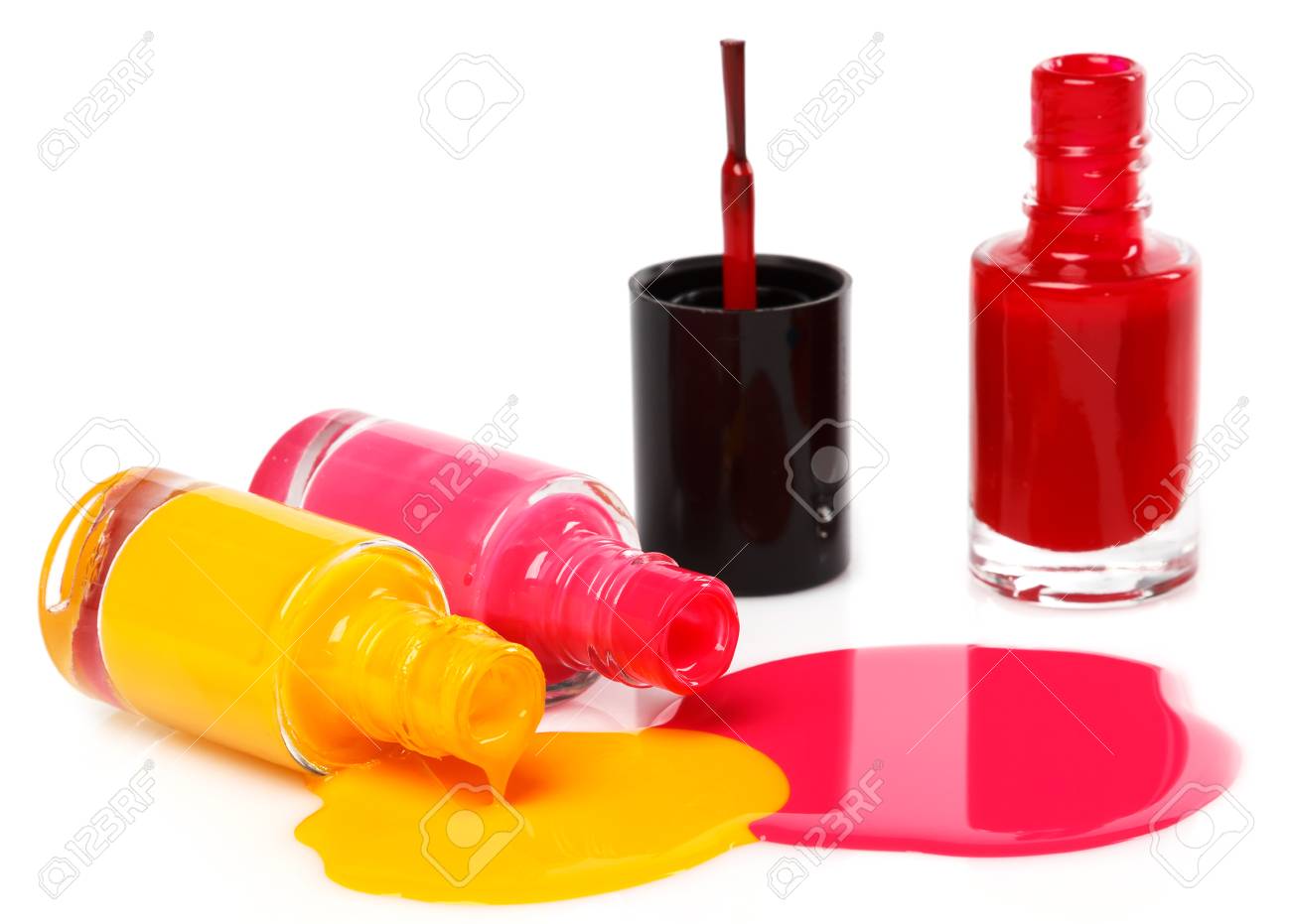 bottles with spilled nail polish on white background stock photo