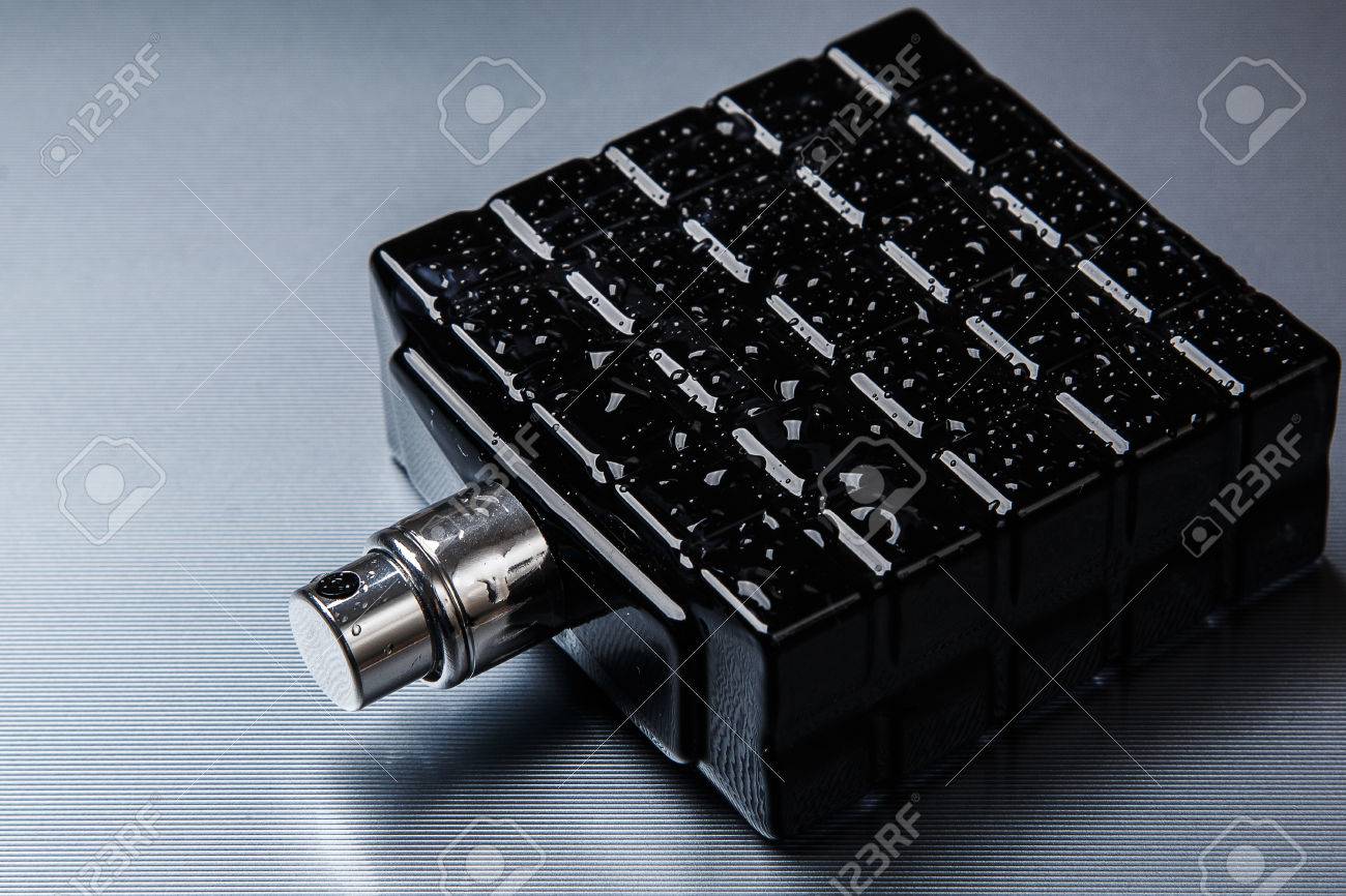 Black bottle of male perfume on metal surface - 41847902 Black bottle of male perfume on metal surface - 41847902