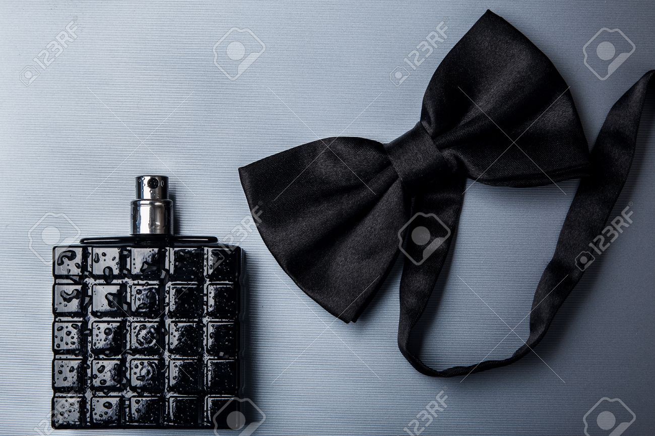 Bottle of male perfume and black bow tie - 41840020 Bottle of male perfume and black bow tie - 41840020