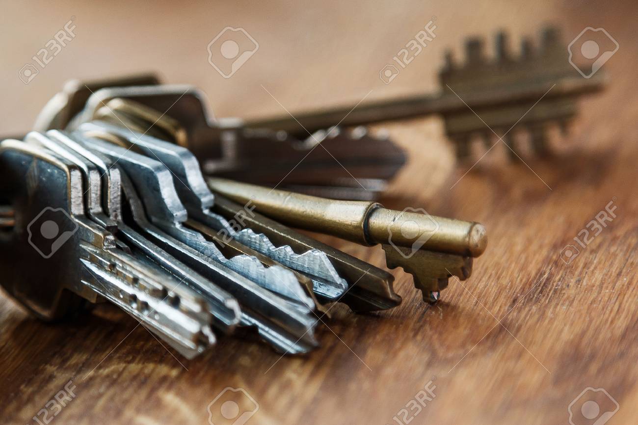 Bunch of different keys on wooden table - 41839888 Bunch of different keys on wooden table - 41839888