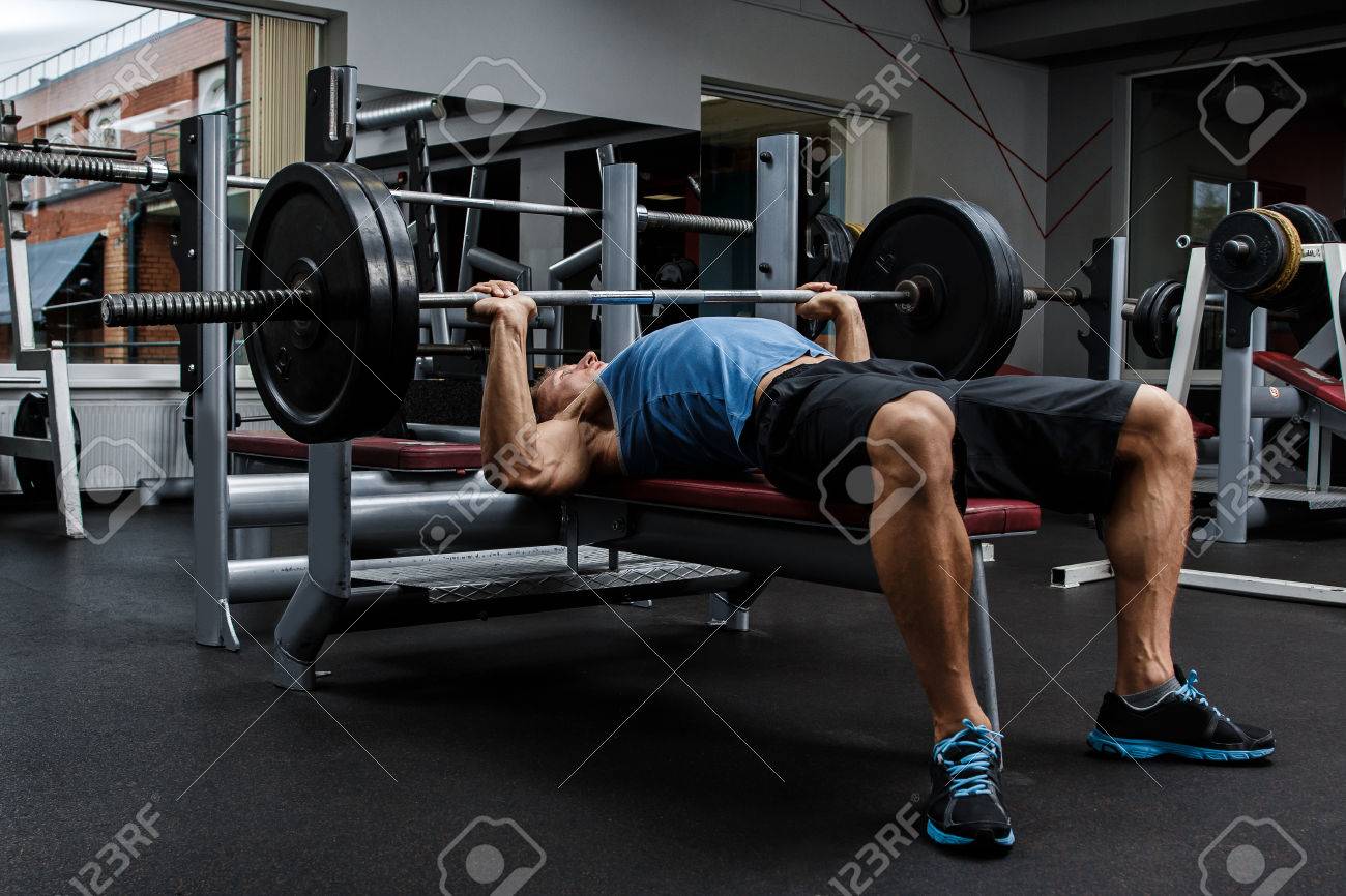 Man during bench press exercise in gym - 56692189 Man during bench press exercise in gym - 56692189