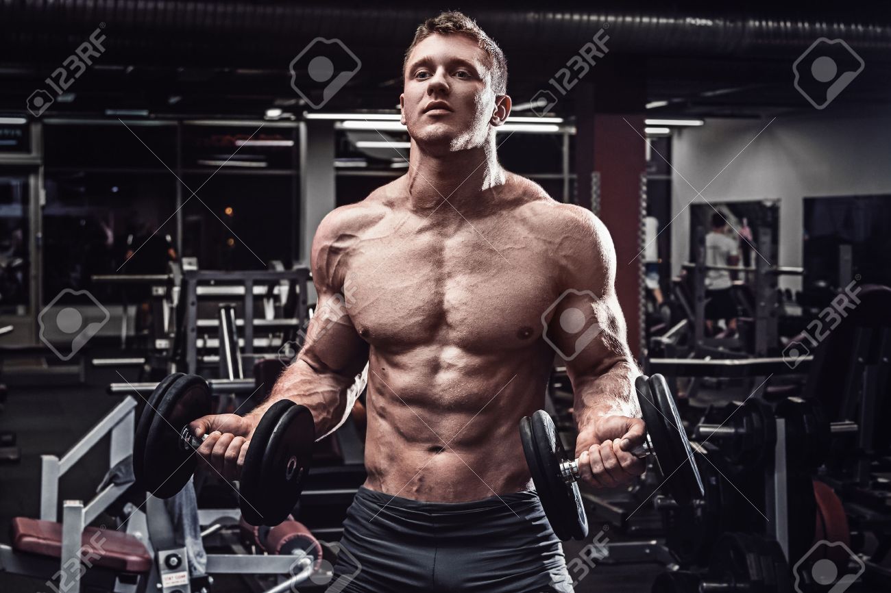 Muscular man with dumbbells in gym - 56658716 Muscular man with dumbbells in gym - 56658716