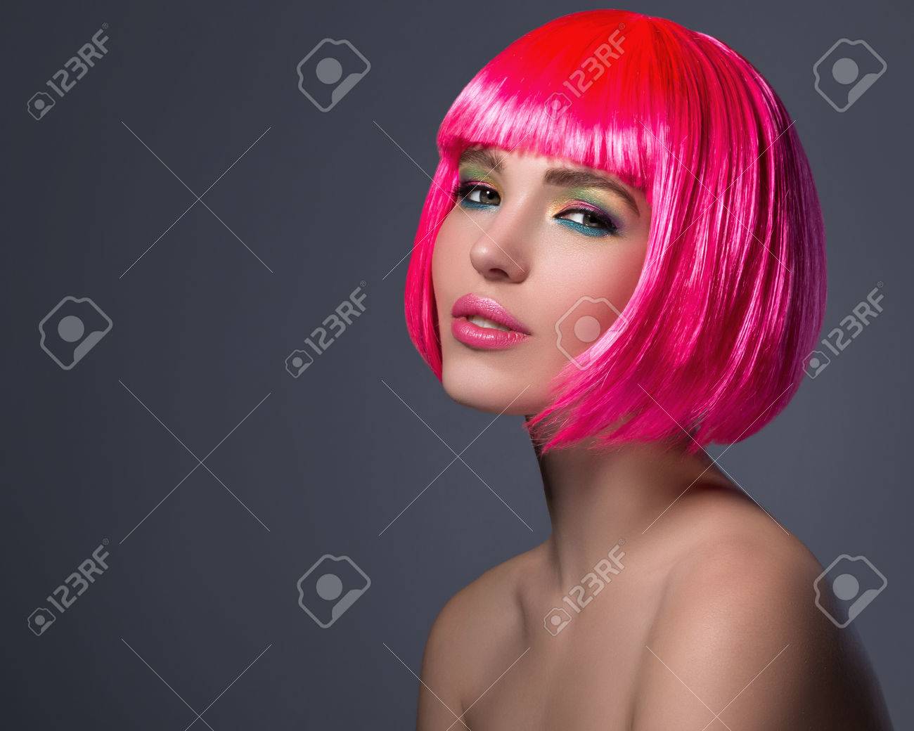 Potrait of young woman with pink hair in studio - 74702210 Potrait of young woman with pink hair in studio - 74702210