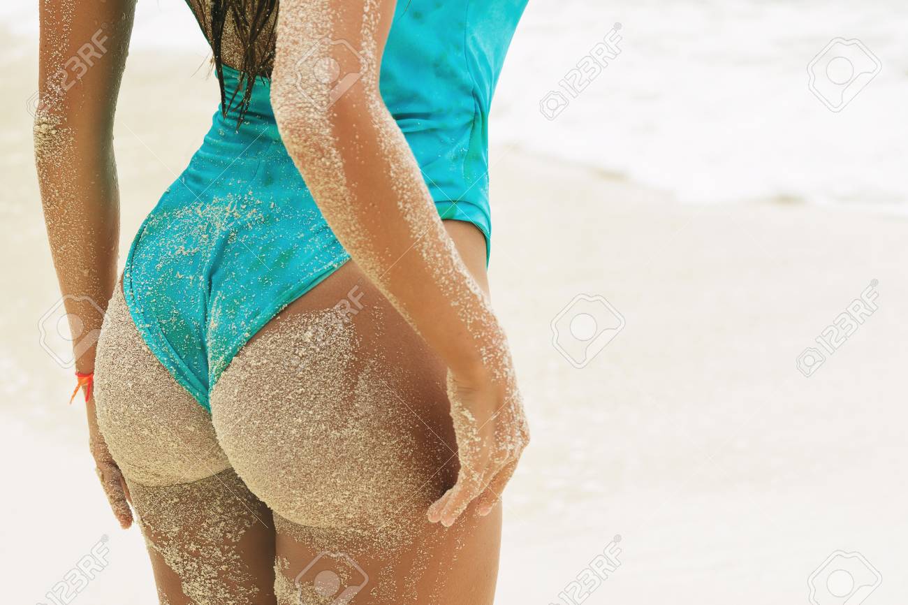 Sexy Female Buttocks Covered With Sand On The Beach Stock Photo, Picture  and Royalty Free Image. Image 109541344.