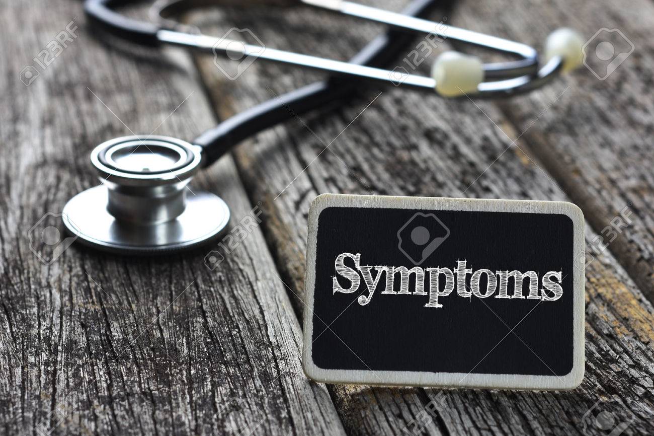 Medical Concept-Symptoms word written on blackboard with Stethoscope on wood background - 57160110 Medical Concept-Symptoms word written on blackboard with Stethoscope on wood background - 57160110