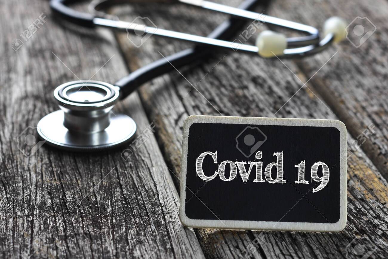 Medical Concept-Covid 19 word written on blackboard with Stethoscope on wood background - 143214743 Medical Concept-Covid 19 word written on blackboard with Stethoscope on wood background - 143214743