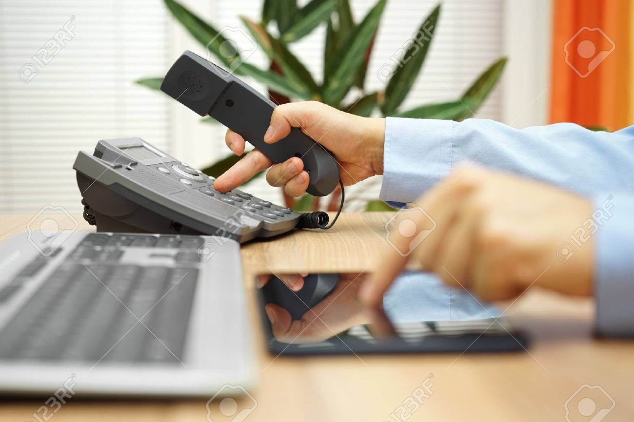 businessman working on tablet computer is calling service for support - 54519570 businessman working on tablet computer is calling service for support - 54519570