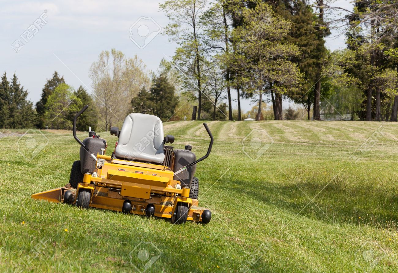 No Person On Expansive Lawn With A Yellow Zero Turn Mower Stock