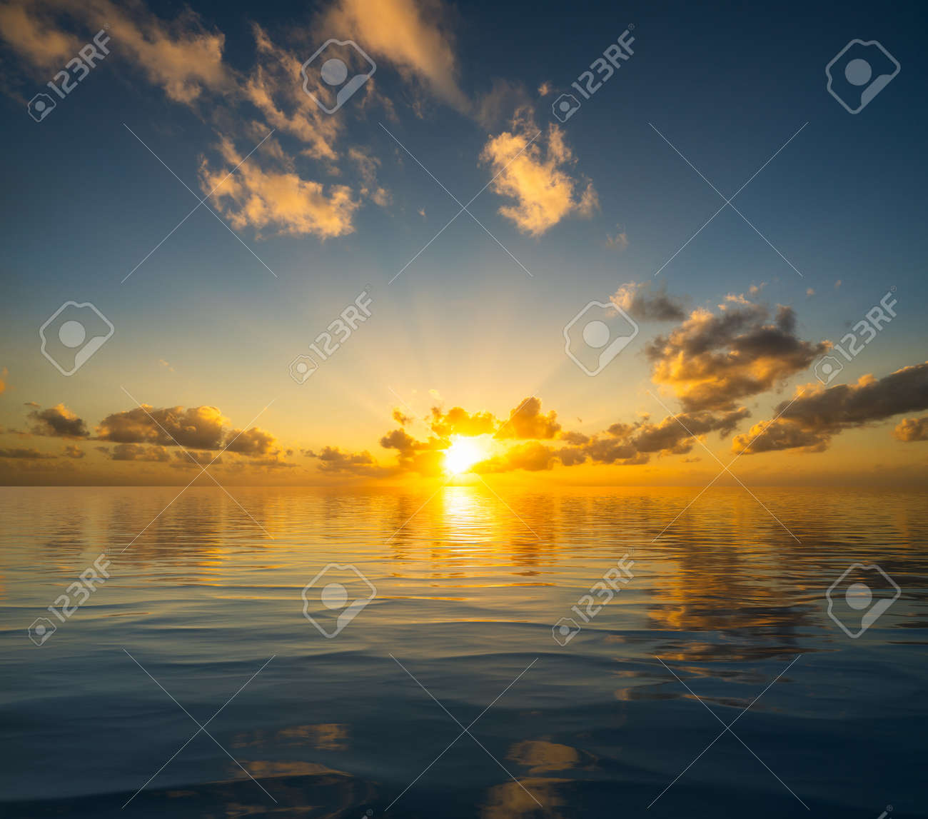 Dramatic sunrise or sunset reflected into the calm waters of an artificial ocean to represent peace or heaven - 154950427 Dramatic sunrise or sunset reflected into the calm waters of an artificial ocean to represent peace or heaven - 154950427