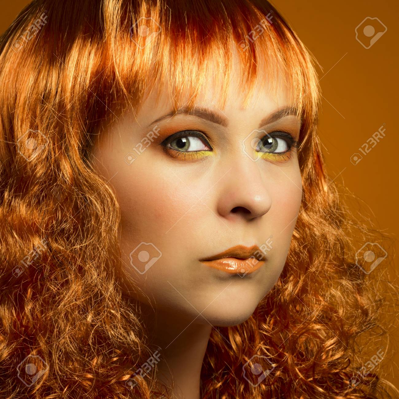 Beauty Portrait Of Woman With Ginger Curly Hairstyle And Orange