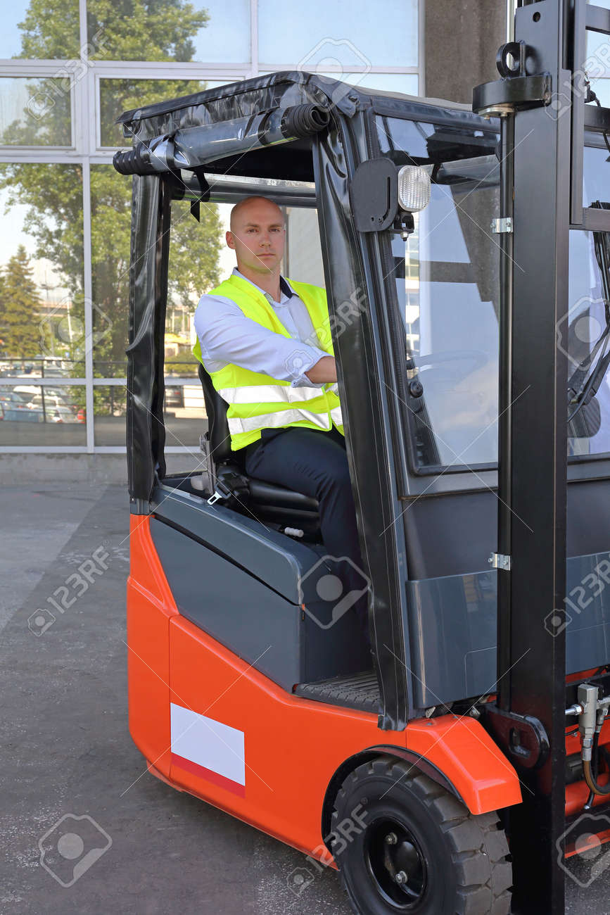 bald driver in forklift cabin with rain cover stock photo picture forklift cover