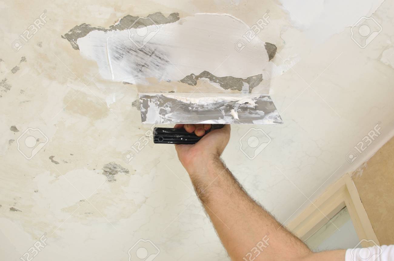 Applying Plaster With A Finishing Trowel To A Ceiling