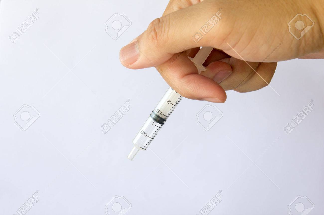 Man hold the plastic syringe on white background - 71019393 Man hold the plastic syringe on white background - 71019393