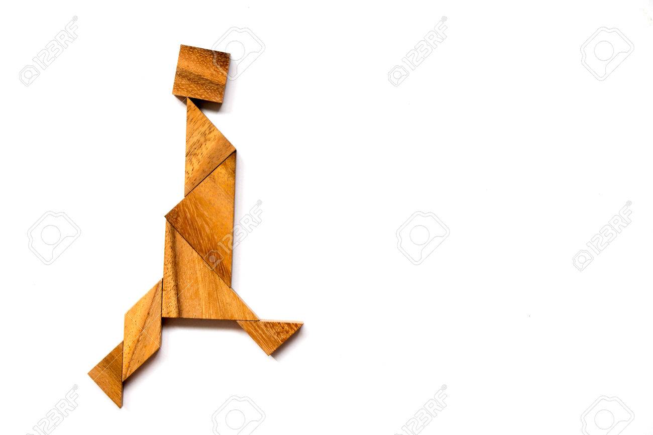 Wooden tangram puzzle in walking man shape on white background - 80384600 Wooden tangram puzzle in walking man shape on white background - 80384600