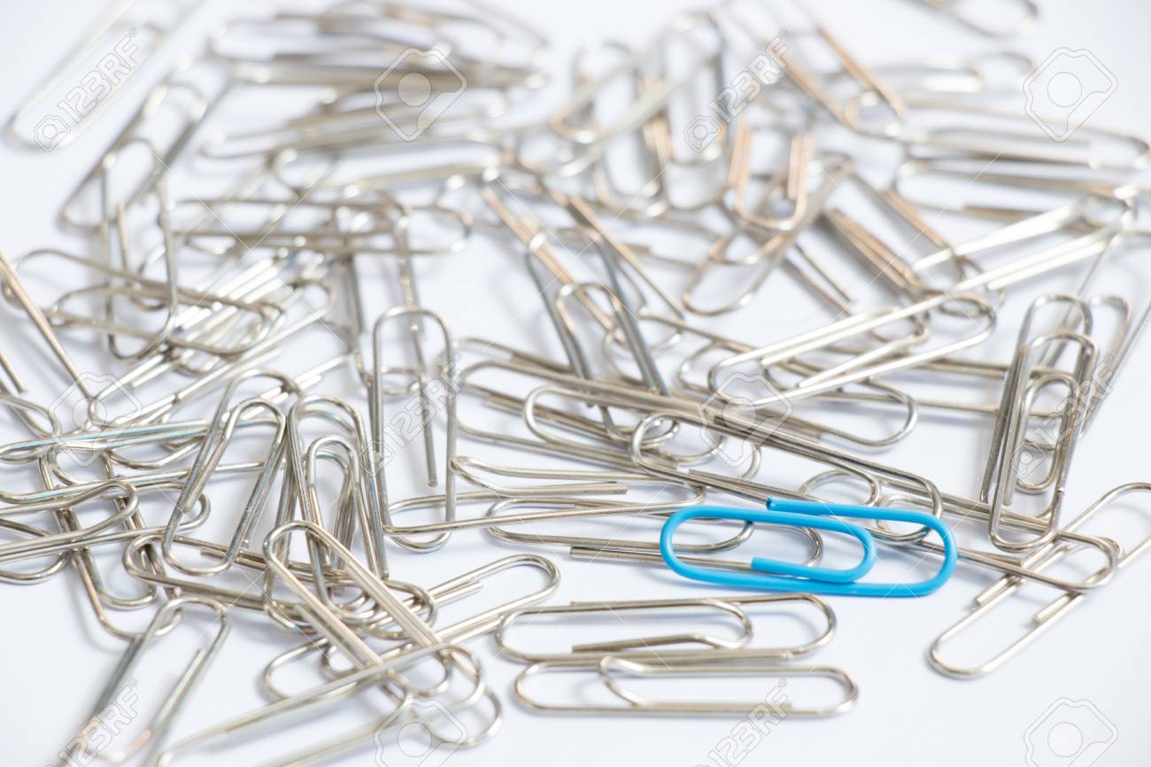 blue color paper clip with another silver item on white background unique paper clip
