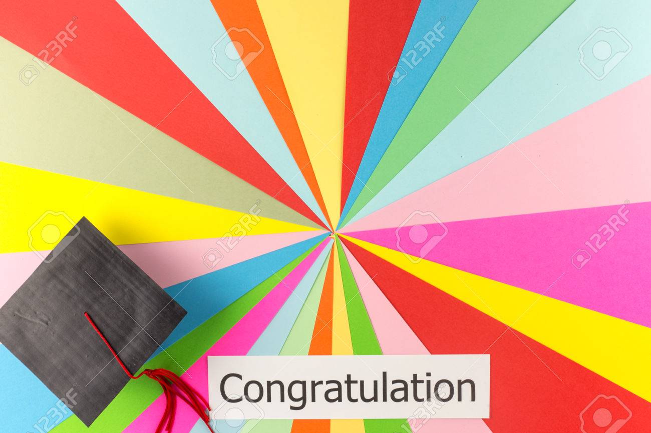 graduation cap and word congratulation on colorful paper background